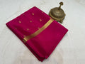 Red saree with gold border and decorative item on a white background