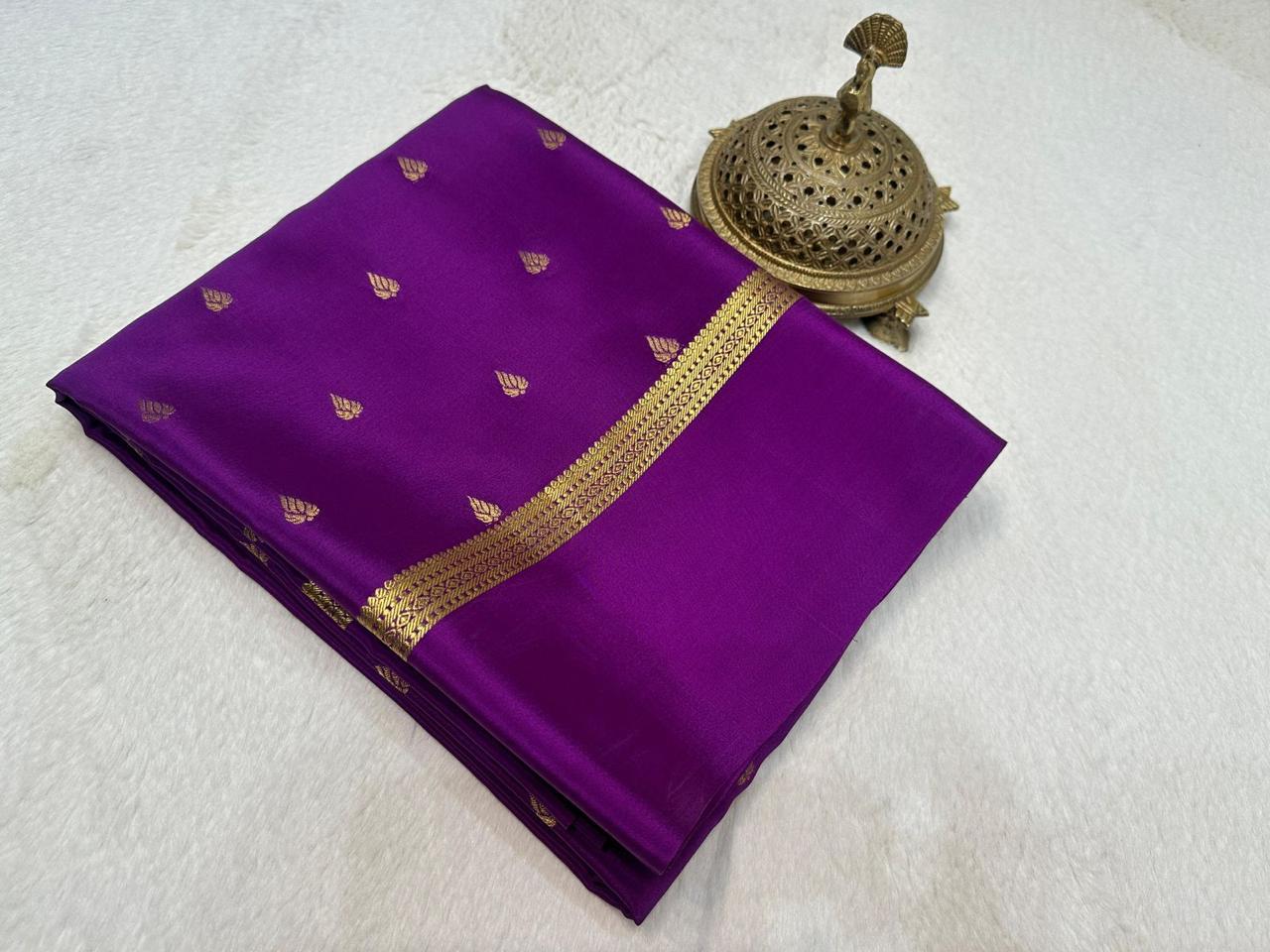 Purple saree with gold border on a white background