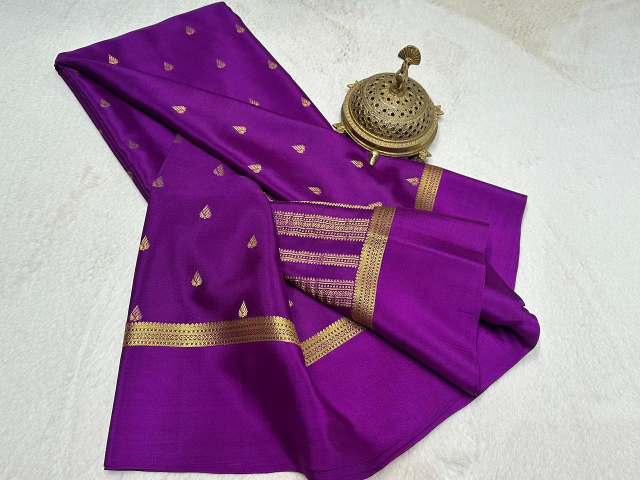 Purple saree with gold patterns on a white surface